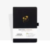 Zwart notitieboek met gouden koala-afbeelding en witte band