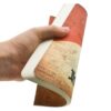 Hand houdt een A5 notitieboek vast met een gestippeld raster en een stripboekthema