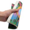 Hand houdt een A5 notitieboek vast met kleurrijk Art Deco-ontwerp op de kaft